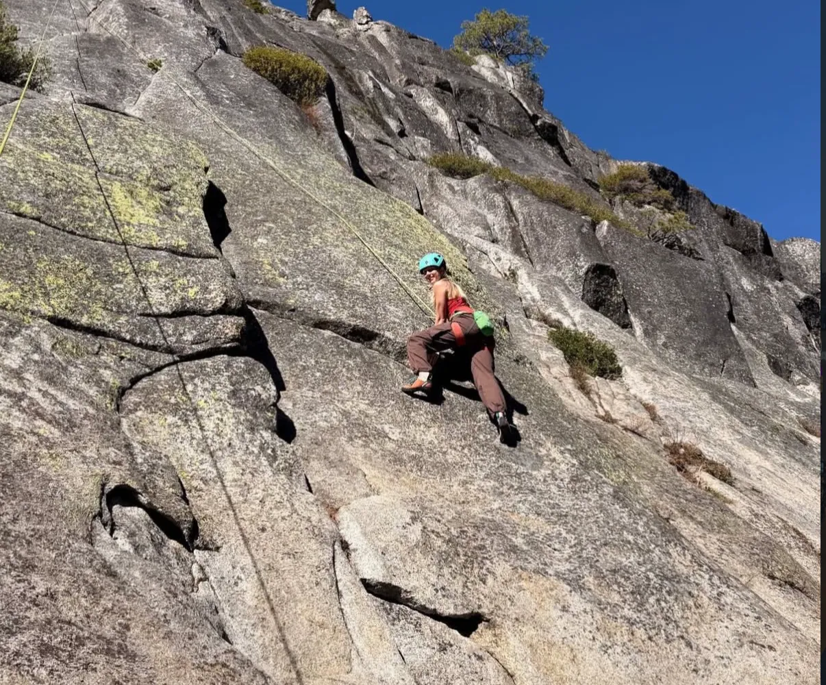 Emersyn climbing a granite slab